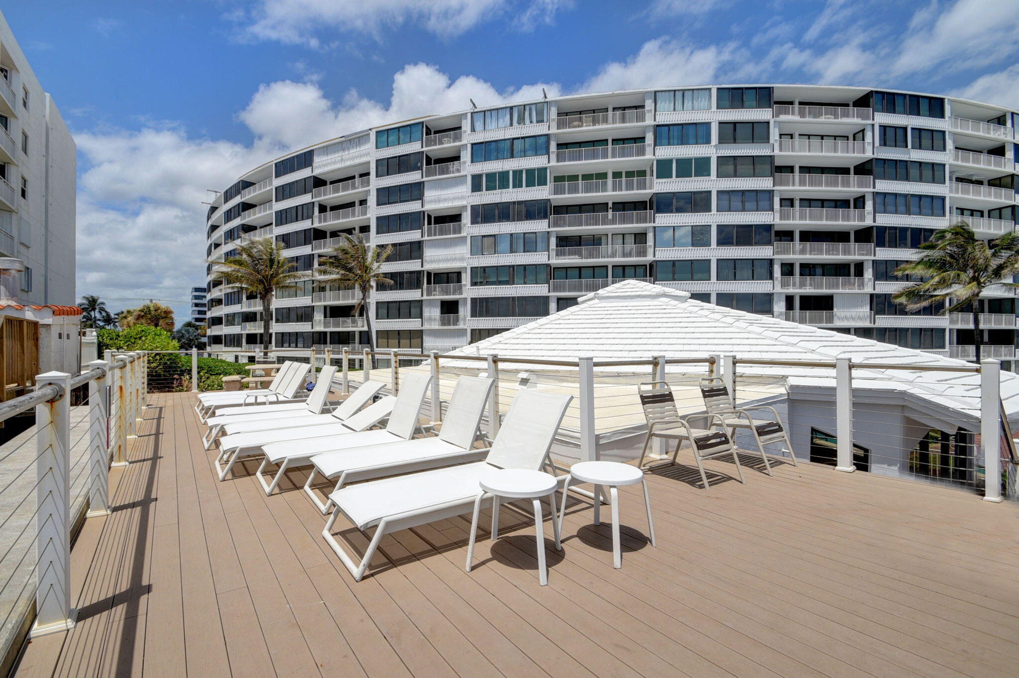 3589 South Ocean Boulevard, Unit 608 South Palm Beach, FL 33480 - Photo 64 of 66 a roof deck with a table and chairs