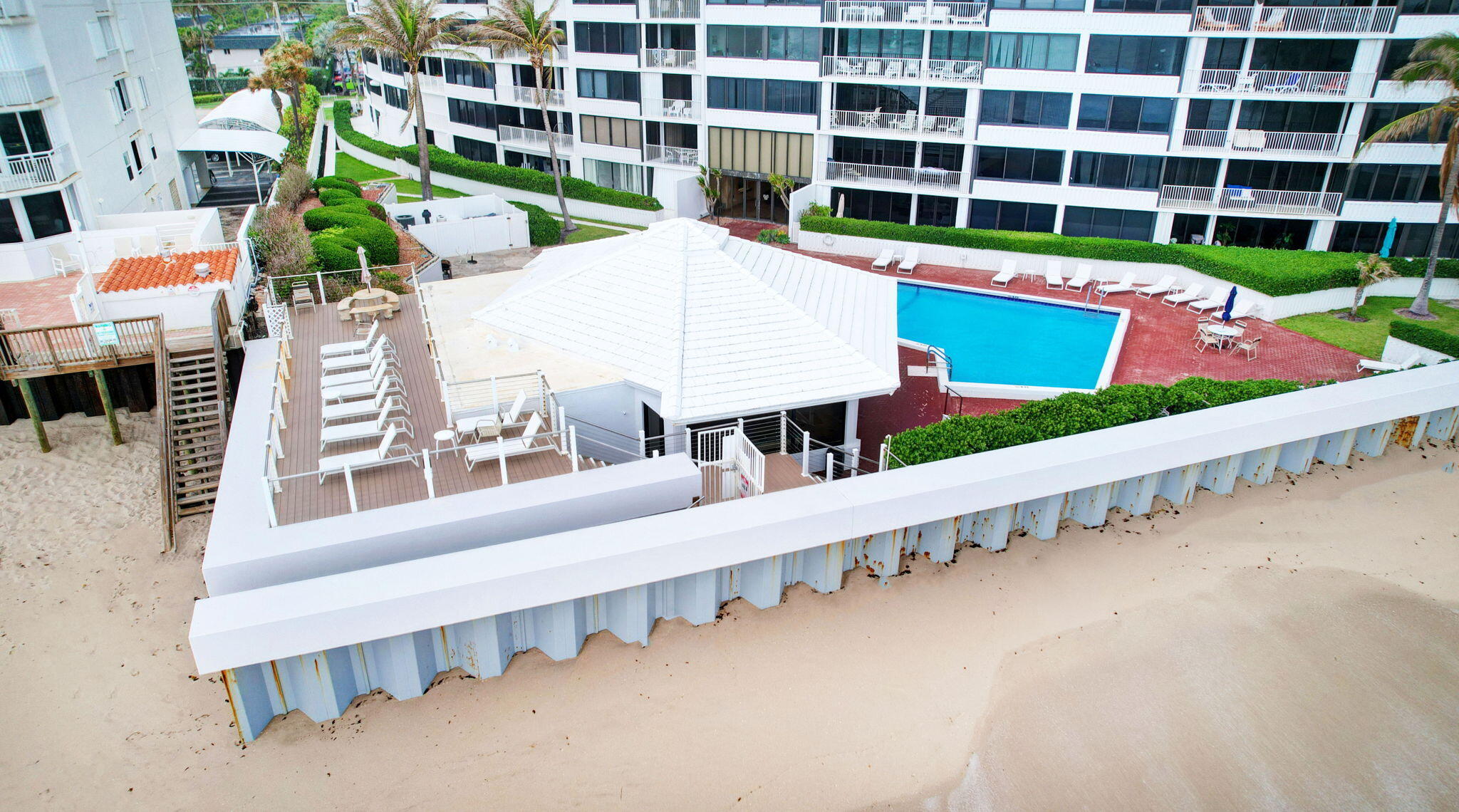 3589 South Ocean Boulevard, Unit 608 South Palm Beach, FL 33480 - Photo 66 of 66 a view of a large building with a yard and plants