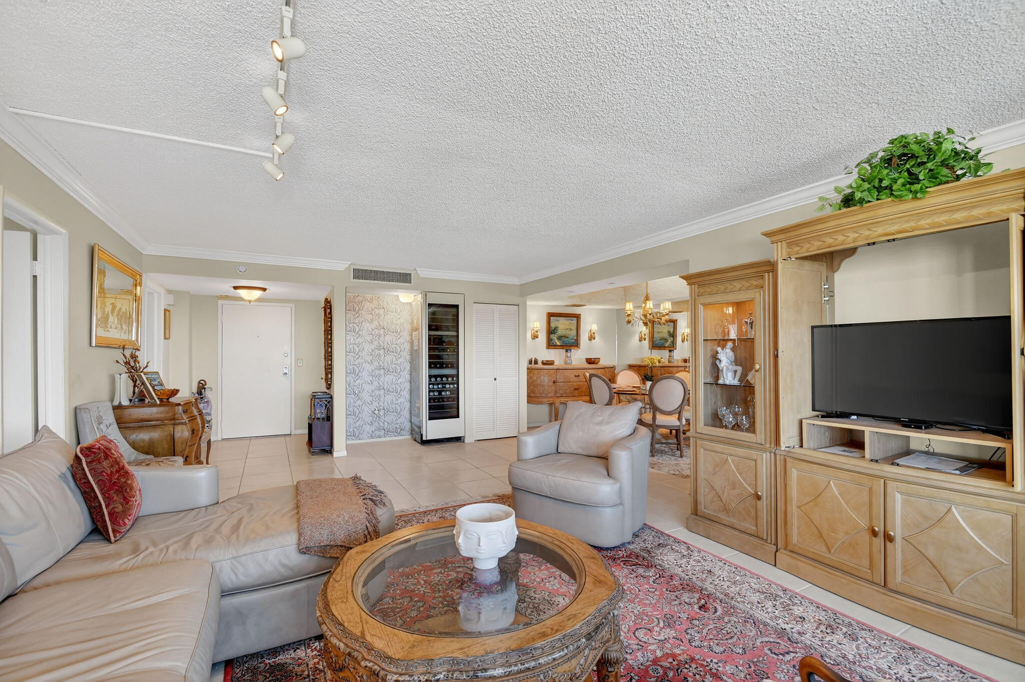 3589 South Ocean Boulevard, Unit 608 South Palm Beach, FL 33480 - Photo 9 of 66 a living room with furniture and a flat screen tv