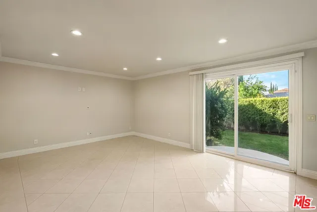 a view of hallway with furniture and a large window