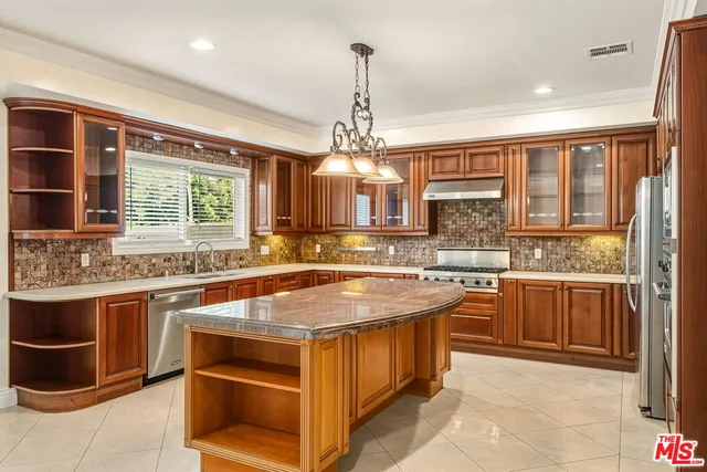 a large white kitchen with a large tub and cabinets