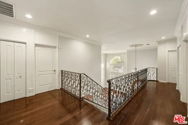 a view of wooden floor and entryway in a room