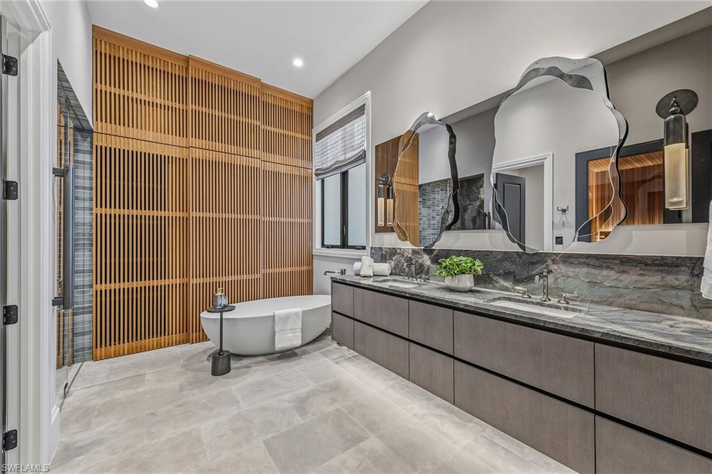 2243 Residence Circle Naples, FL 34105 - Photo 14 of 29 a bathroom with a granite countertop sink and a mirror