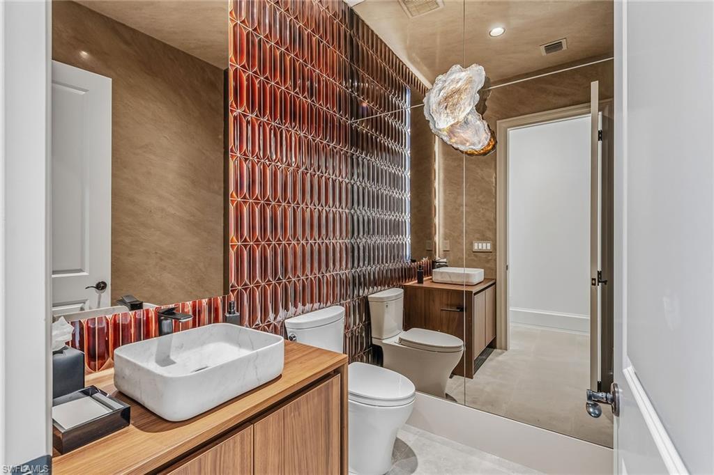 2243 Residence Circle Naples, FL 34105 - Photo 19 of 29 a bathroom with a sink a toilet and shower