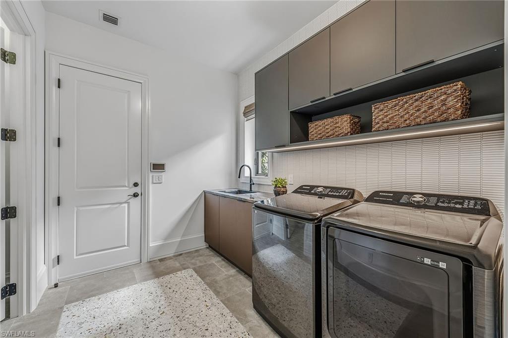 2243 Residence Circle Naples, FL 34105 - Photo 24 of 29 a kitchen with stainless steel appliances granite countertop a stove and a refrigerator