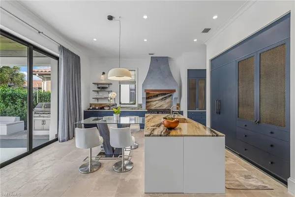 a kitchen with a table chairs refrigerator and microwave