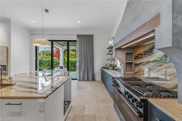 a kitchen with large windows