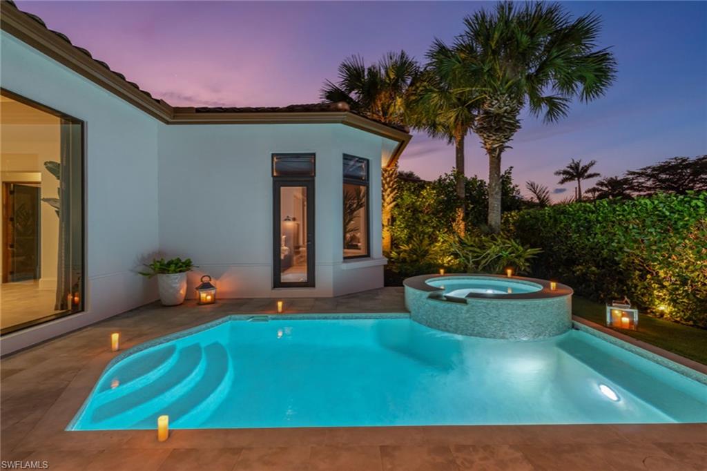 2243 Residence Circle Naples, FL 34105 - Photo 10 of 29 a front view of a house with garden