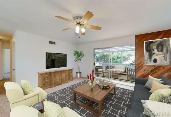 a living room with furniture a flat screen tv and a large window