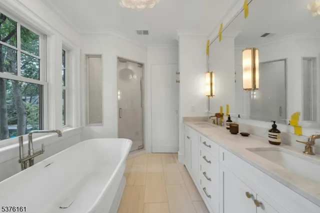 a white bath tub sitting in a bathroom next to a window