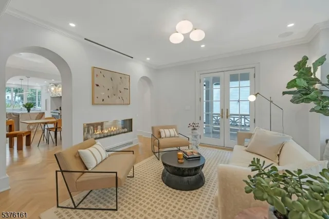 a living room with furniture and stairs