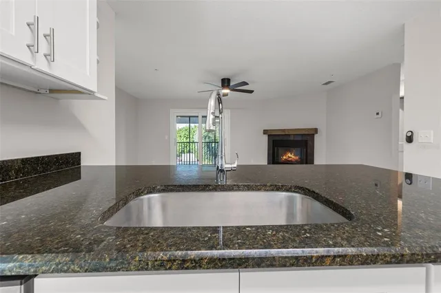 a bathroom with a granite countertop sink and mirror