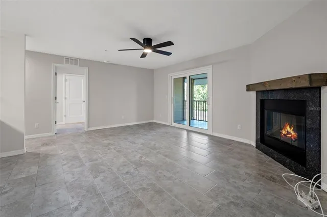 a view of an empty room with window and fireplace