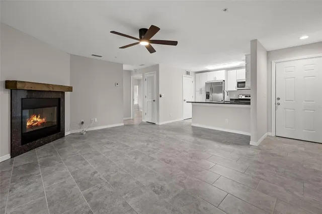 a view of a kitchen with a sink and a fireplace