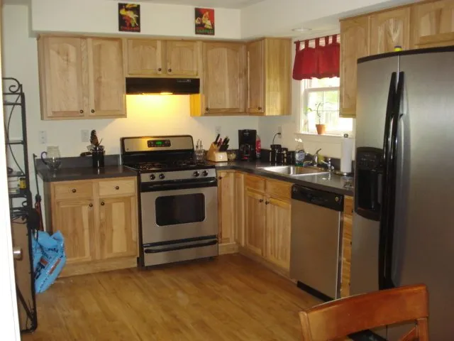 a kitchen with a stove a sink and a refrigerator