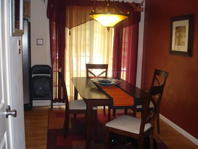 a view of a dining room with furniture and window