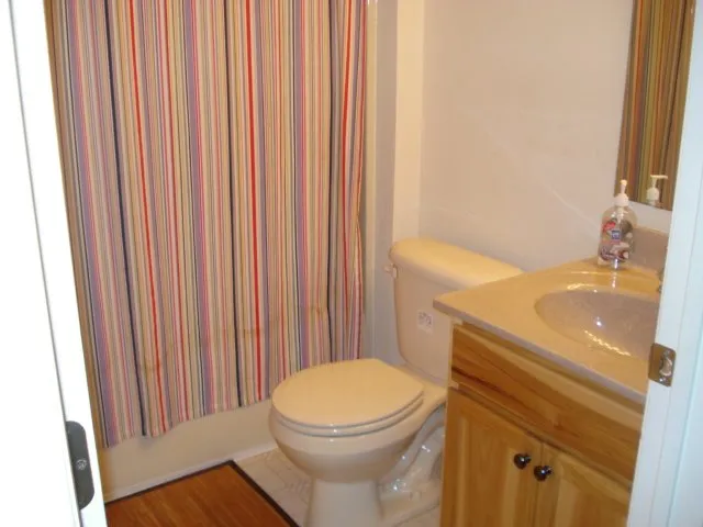 a bathroom with a sink a toilet and tub