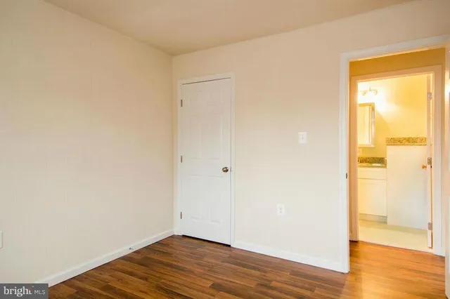 a view of a small space with wooden floor and a window