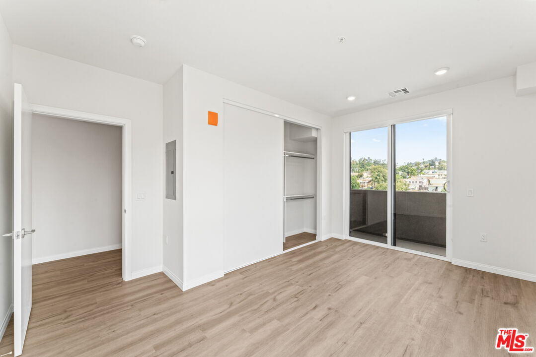 3105 Bellevue Avenue, Unit 405 Los Angeles, CA 90026 - Photo 12 of 26 a view of an empty room with wooden floor and a window