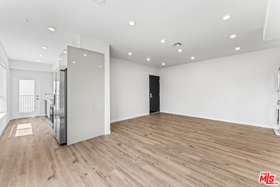 3105 Bellevue Avenue, Unit 405 Los Angeles, CA 90026 - Photo 3 of 26 a view of an empty room with wooden floor