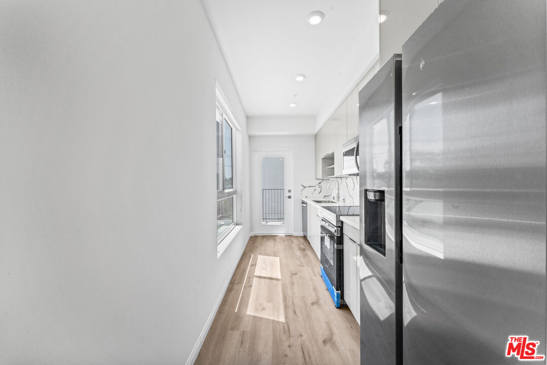 3105 Bellevue Avenue, Unit 405 Los Angeles, CA 90026 - Photo 6 of 26 a view of a hallway view with stainless steel appliances refrigerator
