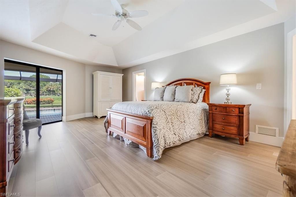 2209 Regal Way Naples, FL 34110 - Photo 21 of 49 a living room with a bed furniture and a large window