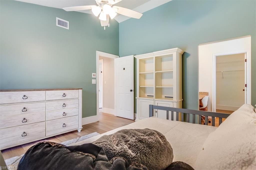 2209 Regal Way Naples, FL 34110 - Photo 33 of 49 a bedroom with a bed and a dresser