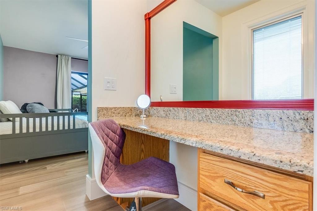 2209 Regal Way Naples, FL 34110 - Photo 34 of 49 a view of a kitchen area with furniture and wooden floor
