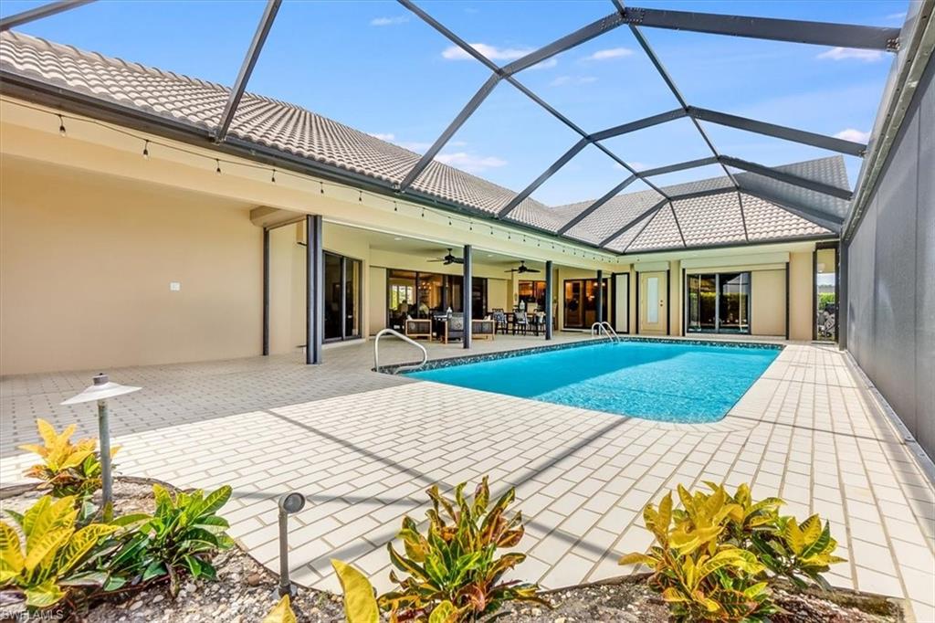 2209 Regal Way Naples, FL 34110 - Photo 41 of 49 a patio with a table and chairs