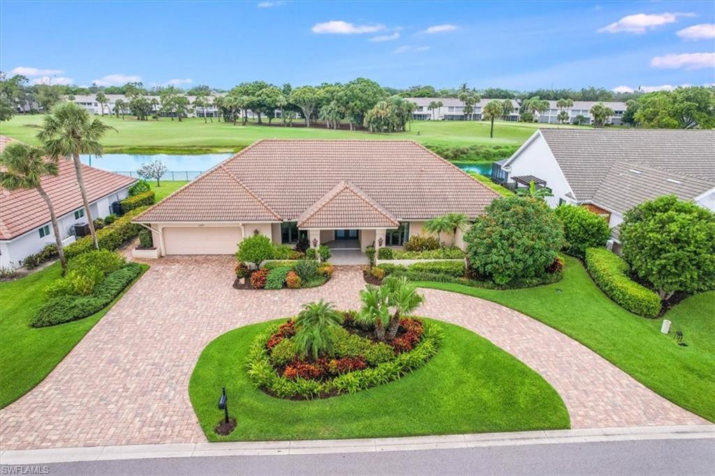 2209 Regal Way Naples, FL 34110 - Photo 46 of 49 a view of a house with a yard and a garden