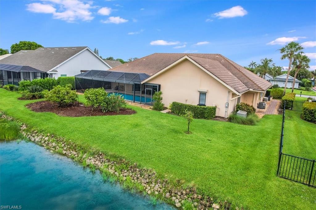 2209 Regal Way Naples, FL 34110 - Photo 48 of 49 a view of front of house with a yard
