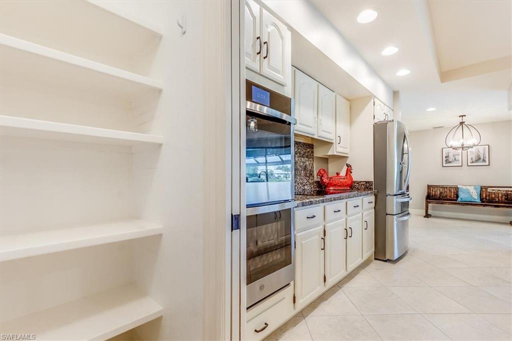 2209 Regal Way Naples, FL 34110 - Photo 10 of 49 a kitchen with stainless steel appliances cabinets and a center island