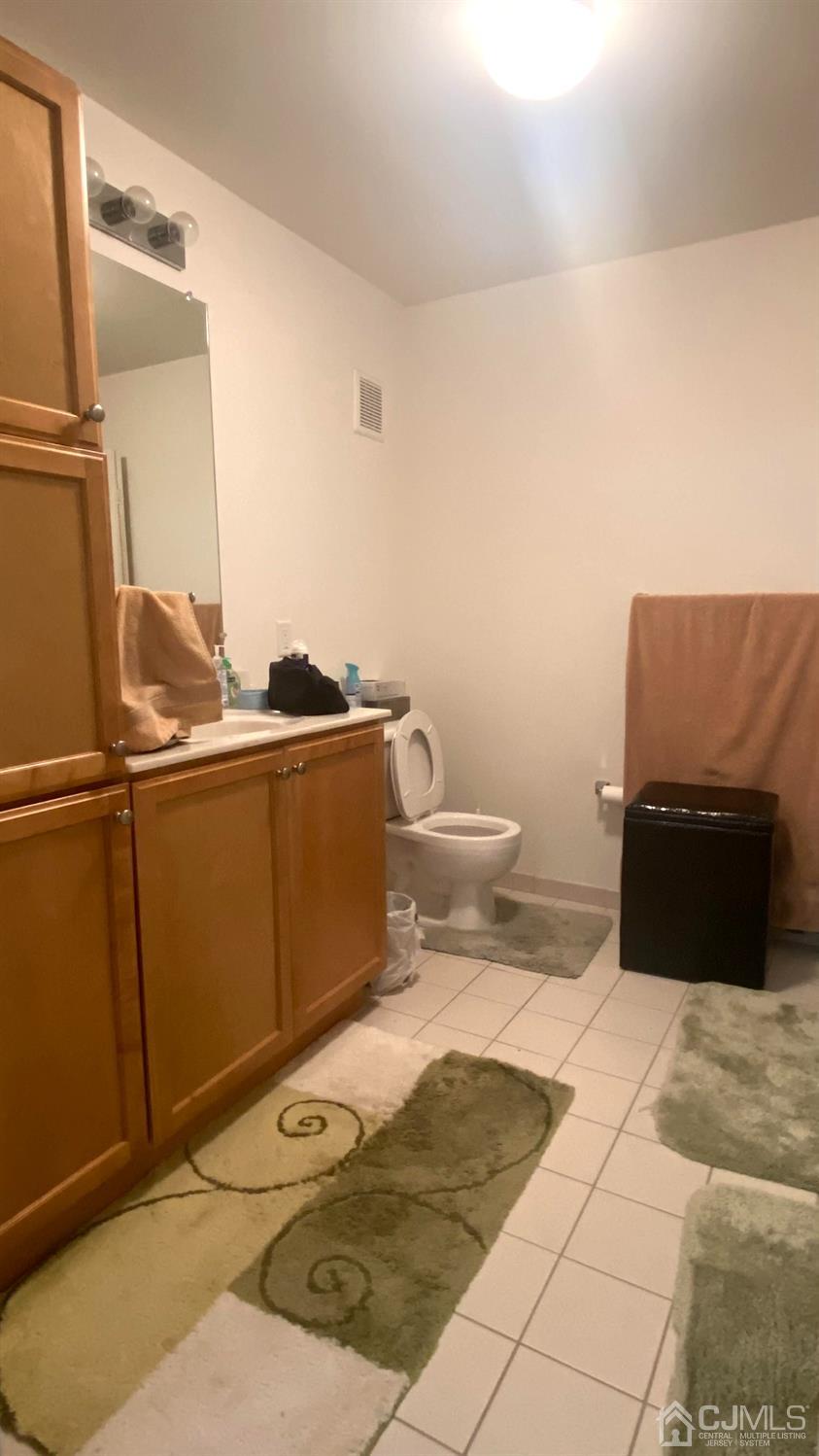 47 Liddle Avenue Edison, NJ 08837 - Photo 13 of 16 a bathroom with a sink toilet and mirror