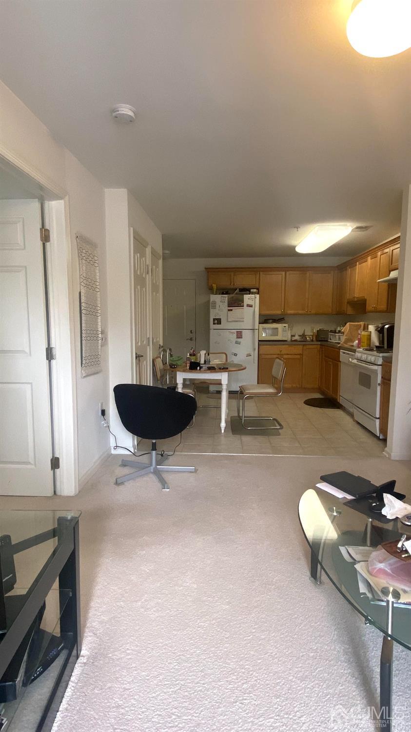 47 Liddle Avenue Edison, NJ 08837 - Photo 8 of 16 a living room with furniture a flat screen tv and kitchen view