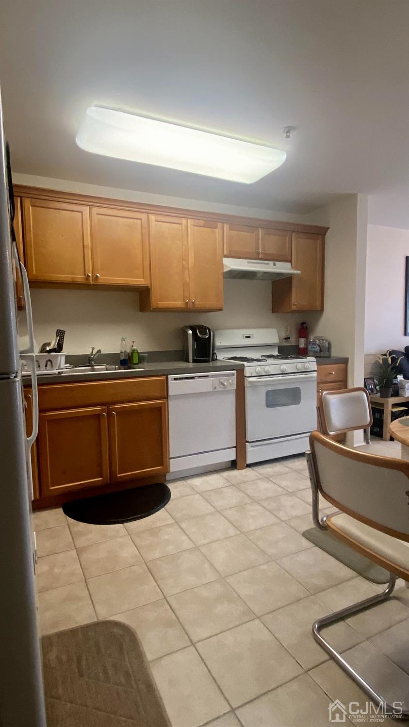 47 Liddle Avenue Edison, NJ 08837 - Photo 10 of 16 a kitchen with a stove top oven and cabinets