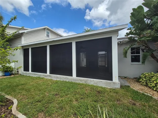 a view of a backyard with a large tree