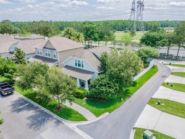 a front view of a house with a yard and garden