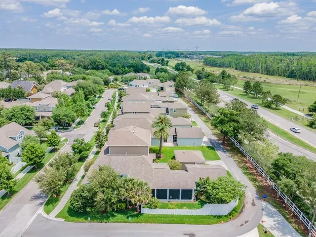 a view of a swimming pool with a yard and plants