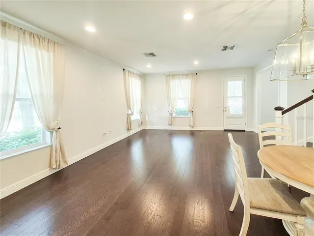 a view of a livingroom with furniture wooden floor and a window