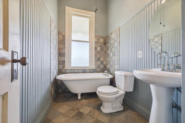 a bathroom with a toilet a sink and a bathtub