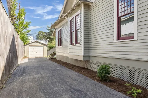a view of a house with a yard and a garage