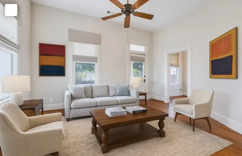 a living room with furniture a lamp and a window