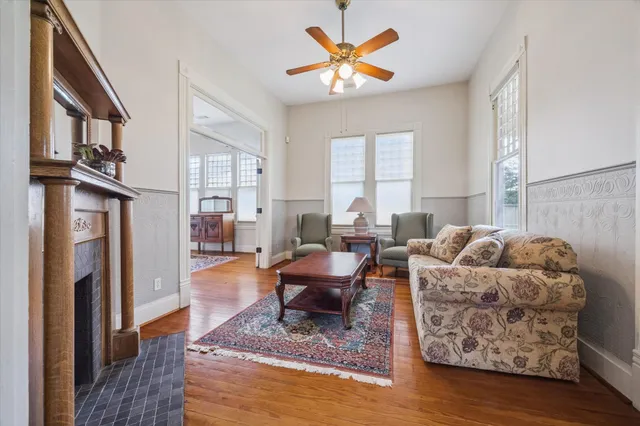 a living room with furniture fireplace and a window