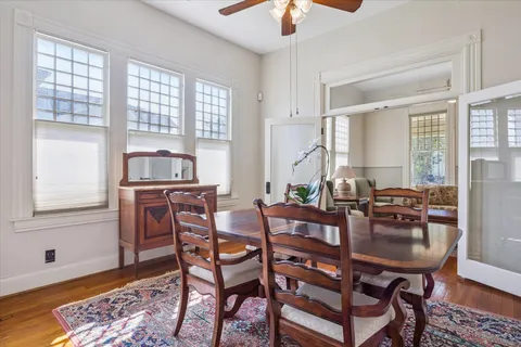a dining room with furniture and window
