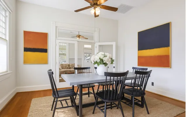 a view of a dining room with furniture and a potted plant