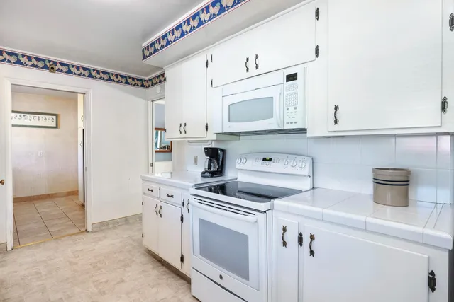 a utility room with a sink dryer and washer