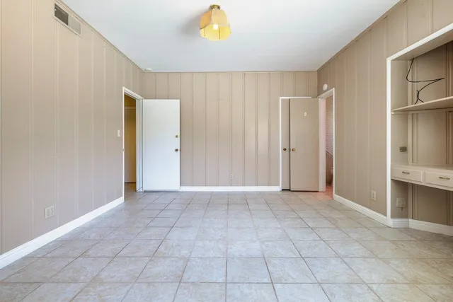 a living room with furniture and a ceiling fan