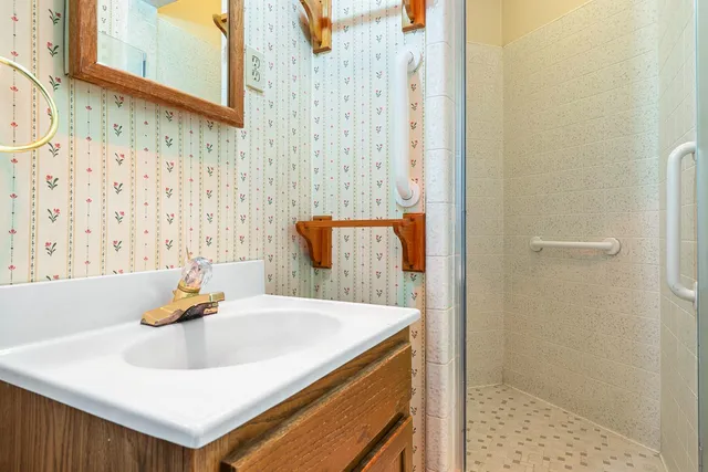 a bathroom with a granite countertop sink and a mirror