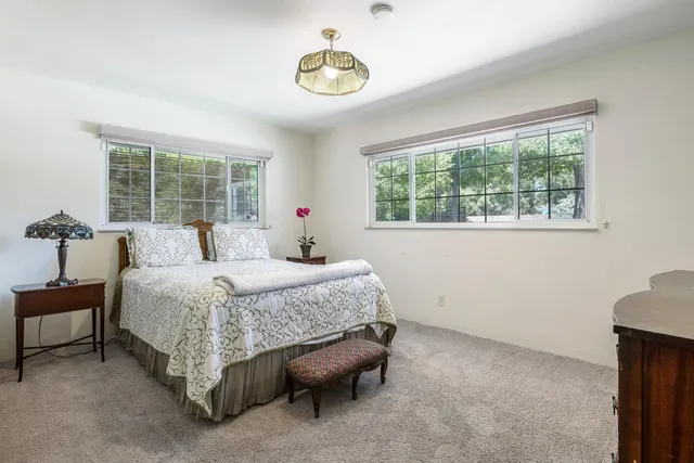 a bedroom with a bed and a chair