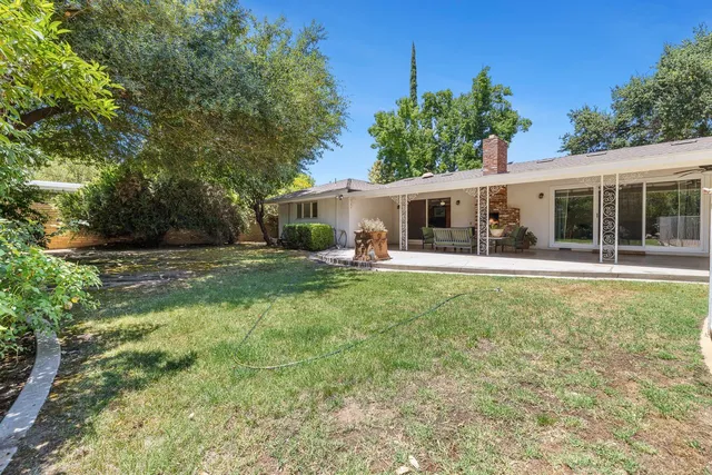 a view of a swimming pool with an outdoor seating and a yard